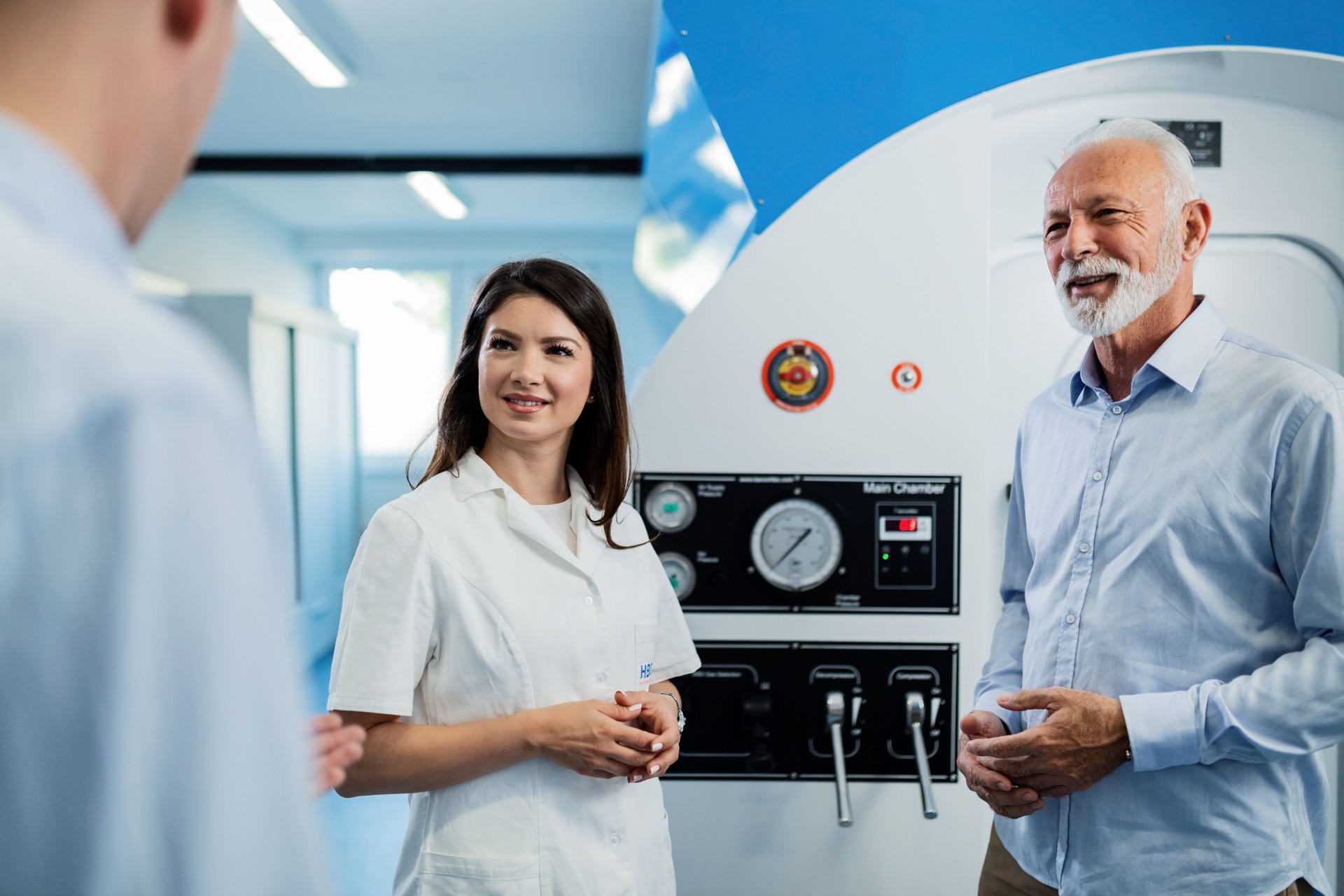 Young smiling doctor and her patients before hyperbaric chamber treatment.